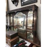 An Edwardian mahogany over mantle with multiple bevel edge mirrors