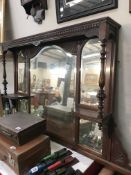 An Edwardian mahogany over mantle with multiple bevel edge mirrors