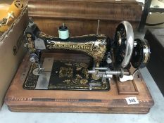 A vintage Frister Rossman sewing machine in inlaid case