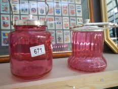 2 x 20th century cranberry biscuit barrels with silver plate tops