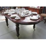 A dark wood stained extending dining table
