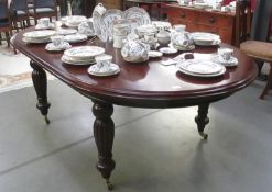 A dark wood stained extending dining table