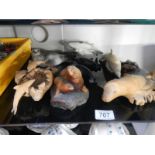 A collection of sea mammals made of wood, stone and porcelain, includes, sea-lion, whale,