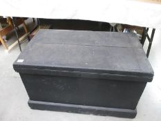 A heavy black painted wooden tool chest