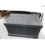 A heavy black painted wooden tool chest