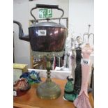 A copper kettle and a brass stand