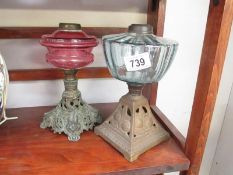 A Victorian cranberry glass oil lamp and 1 other - both missing burners