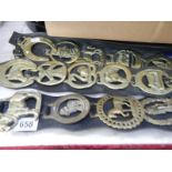 A quantity of horse brasses on 3 leather straps