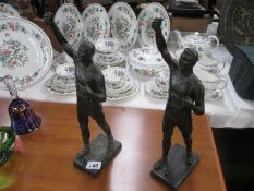 2 spelter male figures with right hand aloft as if carrying items (carried items missing)