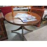 A round dining table on 4 legs with claw feet