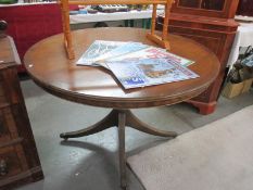 A round dining table on 4 legs with claw feet