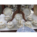 Approximately 32 pieces of teaware featuring yellow floral design