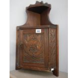 An Edwardian oak wall corner cupboard