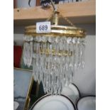 A 3 tier chandelier with glass droppers