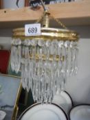 A 3 tier chandelier with glass droppers