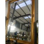 A decorative gilt framed mirror