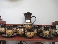 A brown pottery coffee set
