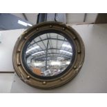 A porthole shaped mirror