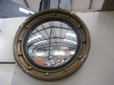 A porthole shaped mirror