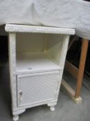 A Lloyd loom style white bedside cabinet