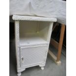 A Lloyd loom style white bedside cabinet