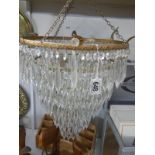 A chandelier with glass droppers (missing approximately 10 droppers)