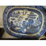 A large willow pattern blue and white meat platter