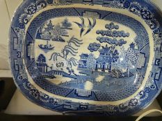 A large willow pattern blue and white meat platter