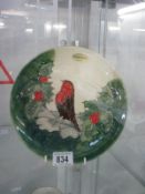 A Moorcroft Christmas plate featuring a robin and holly ****Condition report**** A