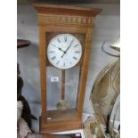 A modern oak cased London clock Co Westminster Whittington wall clock