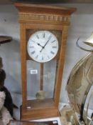 A modern oak cased London clock Co Westminster Whittington wall clock