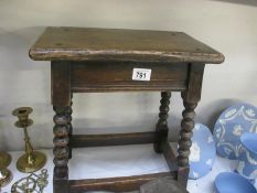 An old wooden stool with barley twist legs