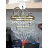 A vintage 3 tier chandelier with glass droppers