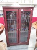 A glazed 2 door cabinet