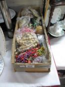 A box of costume jewellery and beads