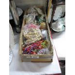 A box of costume jewellery and beads