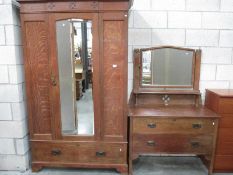 A large mirror fronted oak wardrobe and a 2 drawer dressing table