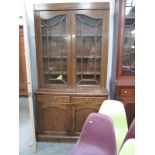 An Edwardian oak astragal glazed top bookcase