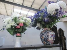 2 vases with artificial flowers