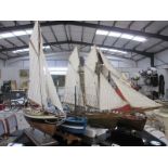 A collection of 4 wooden models of sailing boats (3 with stands)