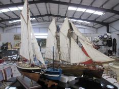 A collection of 4 wooden models of sailing boats (3 with stands)