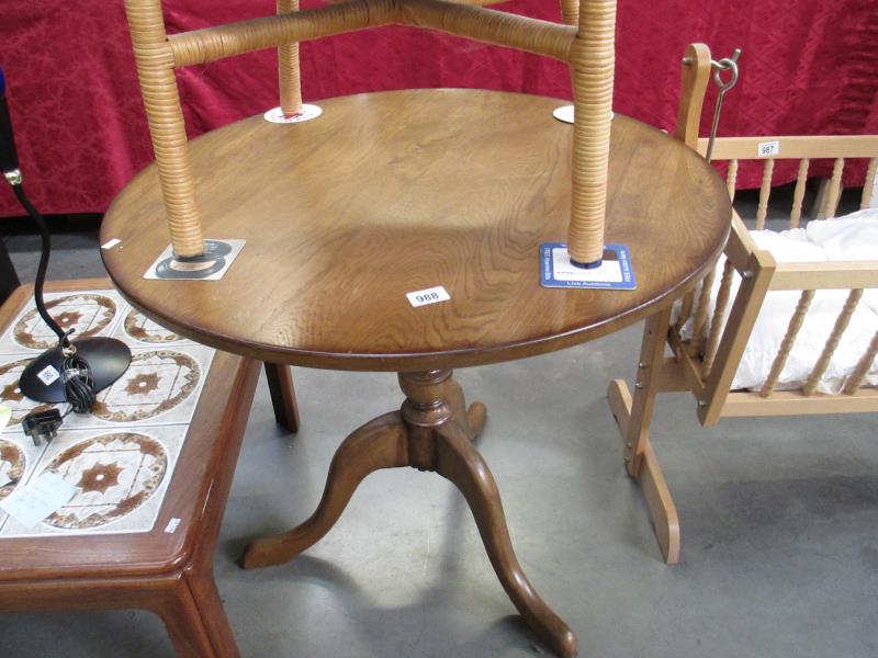 An oval table on tripod legs