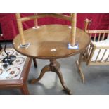 An oval table on tripod legs