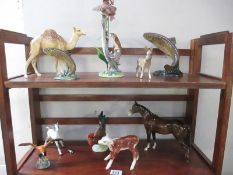 A collection of Beswick animals, all damaged with some repaired including Camel, Salmon, Donkey,