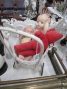 An old pram and quantity of old dolls