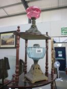 A Victorian cranberry glass oil lamp and 1 other - both missing burners
