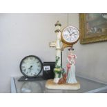 A figural clock of lady by lamp post and a clock with side pot