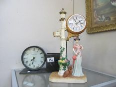 A figural clock of lady by lamp post and a clock with side pot