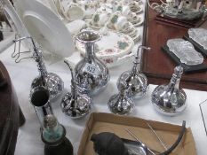 A collection of polished silver flasks and cannisters etc