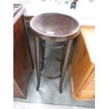 A tall dark wood stool